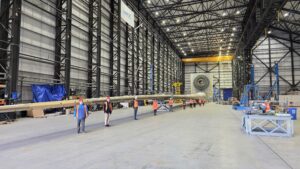 People stood in front of a wind turbine blade